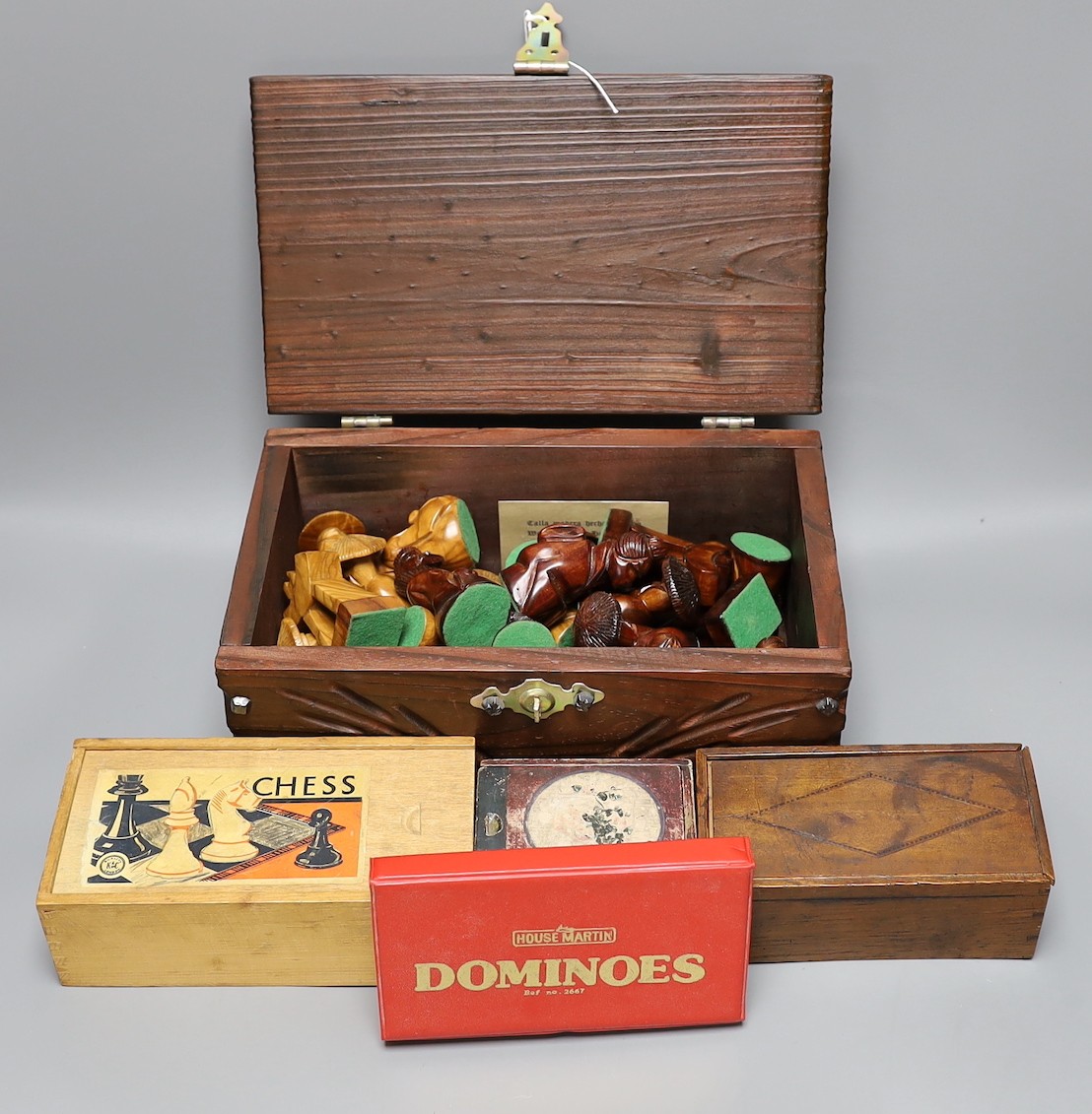 A Chinese carved wood chess set in carved mahogany box, together with three others and a dominoes set